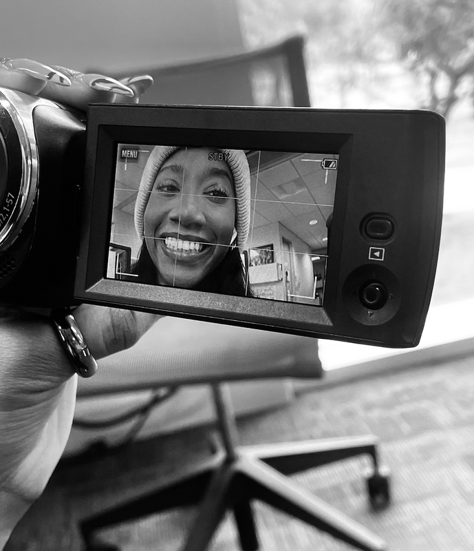 Black and white photo of Jayla framed in a camera's flip-out screen